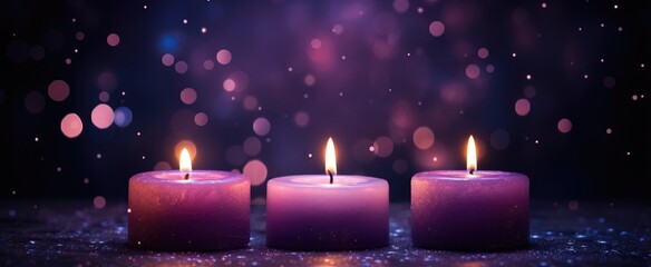 Three lit purple candle on dark background. Spa treatment with light effect. Bokeh light for meditation and relaxation.