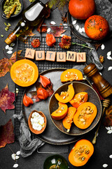 Autumn composition of pumpkins, dry leaves and flowers. Autumn menu. Pumpkin menu. Top view.