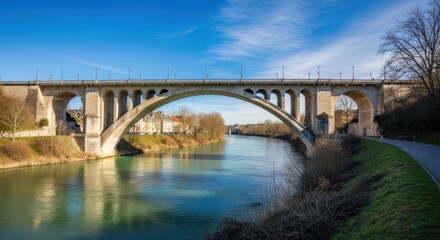 Obraz premium Stone arch bridge spans tranquil river