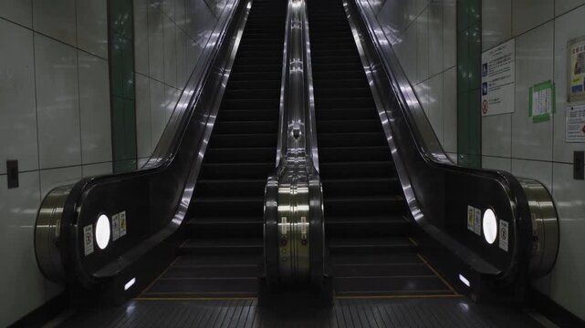 kyoto, japan - 2 july 2025 escalators in symmetry going up and down