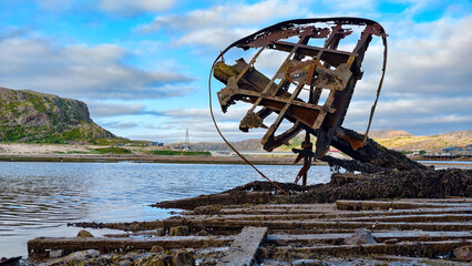old abandoned sunken ship in the water at the ship cemetery wood pattern