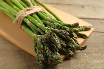 Vegan healthy food. Fresh green asparagus on a board