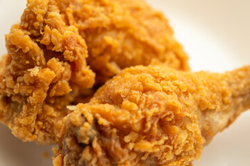 crispy fried chicken on white plate close up