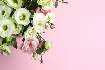 Bouquet of eustoma flowers on a pink background