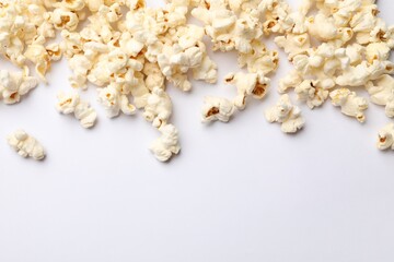 Tasty popcorn on white background, flat lay. Space for text