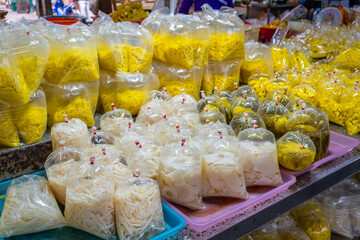 Freshly packed pickled bamboo shoots, boiled bamboo, and preserved mustard greens, displayed at a...