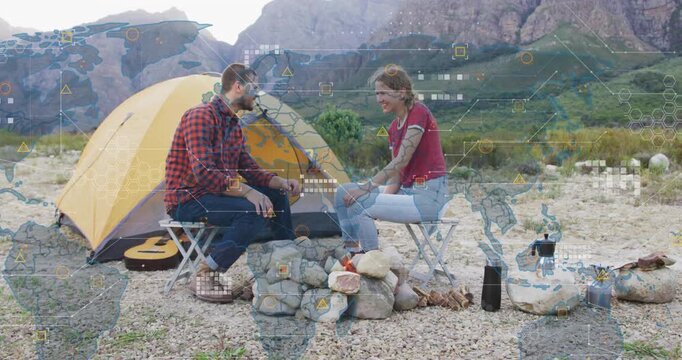 Couple chatting at campsite, initiating technology overlay with world map nodes appearing overhead