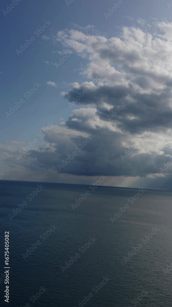 Aufkleber dynamic video concept with a tilted camera angle capturing a serene ocean horizon under a vast sky, 