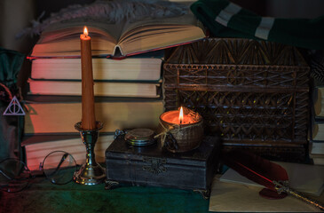 Dark style, books and other academia or school stuff on a table, autumn evening time 