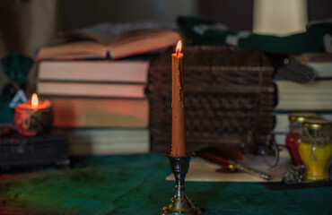 Dark style, books and other academia or school stuff on a table, autumn evening time 
