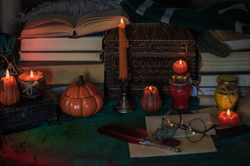 Dark style, books and other academia or school stuff on a table, autumn evening time 