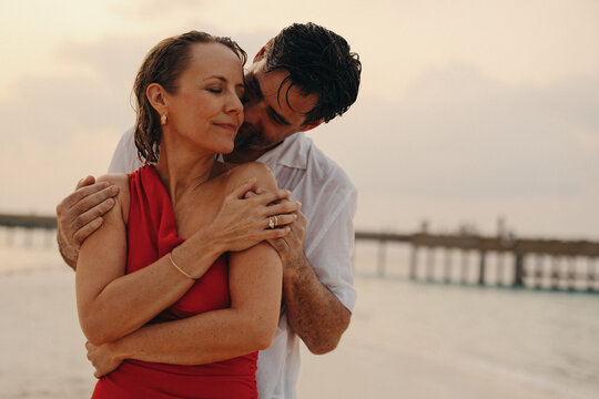 Romantic moment for older couple on honeymoon at the beach - Powered by Adobe