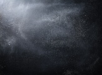 Dark gray surface with light gray streaks and speckles