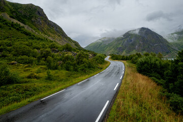 Drone aerial Scenic Road Through Lofoten Mountains and Fjord, in Norway. Aerial View