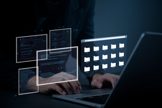 Hacker typing on laptop with digital file folders and coding interface, concept of cyber attack, data theft, information security breach, and online privacy risk. - Powered by Adobe
