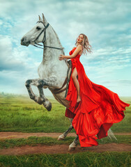Happy woman sitting on horseback fashion model posing. trained horse rears up on its hind hooves,...