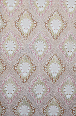 Old wallpaper on the wall. Old wallpaper for texture or background.