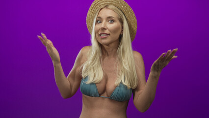 Woman lifts bare arms revealing bikini top and straw hat on a purple studio set under bright...