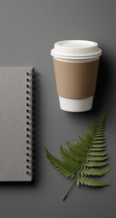 White Notebook with Gold Binding and Mockup Card Beside Glitter Coffee Cup and Fern