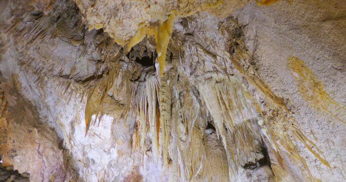 Stalactites And Stalagmites Inside The Karst Caves. Low Angle Shot