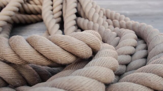 A rope covered rolled in coil in daytime in the port.