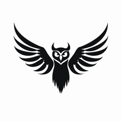 Obraz premium Majestic owl with open wings in striking black graphic silhouette