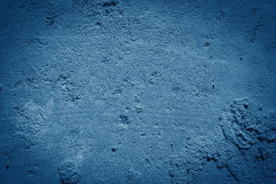 Old blue wall in spots, cracks, stains. Painted concrete wall in abstract grunge style loft.