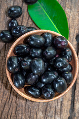 Jambolan plum, Java plum, Jambul( Syzygium cumini (L.) Skeels. on wooden background