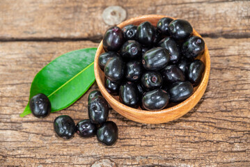 Jambolan plum, Java plum, Jambul( Syzygium cumini (L.) Skeels. on wooden background
