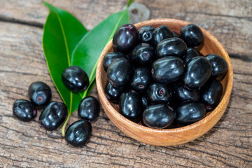 Jambolan plum, Java plum, Jambul( Syzygium cumini (L.) Skeels. on wooden background