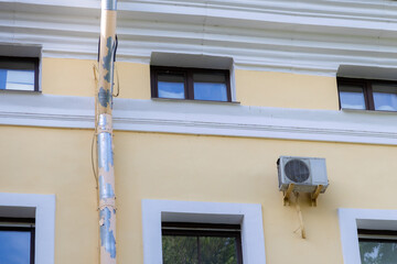 air conditioner is mounted on the wall. technologies for air cooling in hot weather. air temperature, climate control. ventilators in the home and office. installation of an air ventilation system.