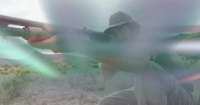 Shooter pumping shotgun and aiming off-screen target amid desert light streaks conveying defense