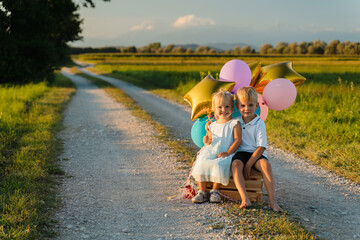 Portrait of two little children on nature. Photography of only children, smiling sibling.