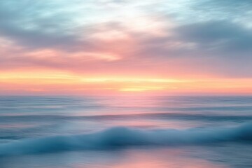 Obraz premium Calm ocean waves gently rolling under a vibrant, colorful sunset sky with soft clouds and serene horizon