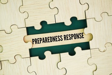 Wooden puzzle with the words preparedness and response. emergency concept. ensure safety by...