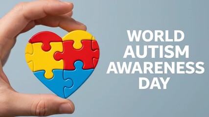 Hand Holding a Heart-Shaped Puzzle for World Autism Awareness Day on a Blue Background
- Powered by Adobe