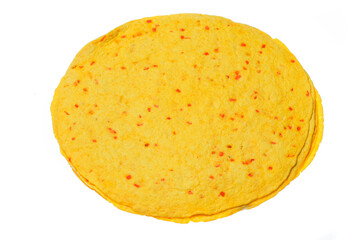 Top view of round dry flatbread with red specks on white background.