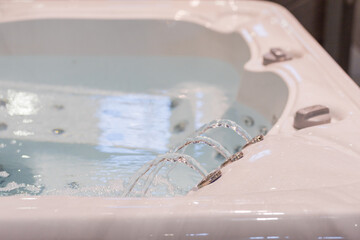 Modern hot tub with bubbling water and jets creating a relaxing spa atmosphere
