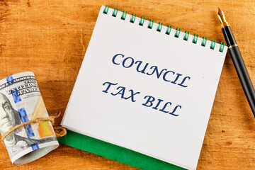 Business and finance concept. The inscription COUNCIL TAX BILL on a blank sheet of notepad against a papyrus background