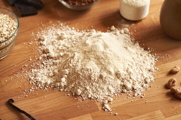 Ground oat flakes, whey protein powder and hazelnut butter - ingredients for homemade protein chocolate bars