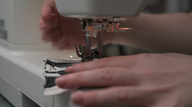 Sewing stripes on fabric at home during an evening crafting session
