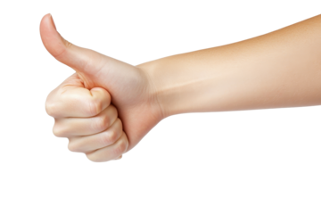 Woman gestures with a thumbs down, expressing disapproval against a plain white background during daylight
