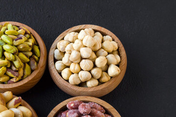 Double roasted, luxurious Turkish hazelnuts designed in a bamboo bowl on black surface