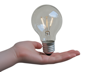Holding an illuminated light bulb in a hand, symbolizing ideas, innovation, and creativity in a clear and isolated setting during the day
