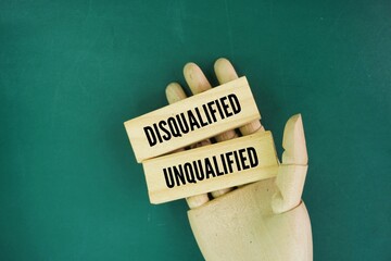 Wood with two words disqualified and unqualified. Unqualified is made up of the adjective...