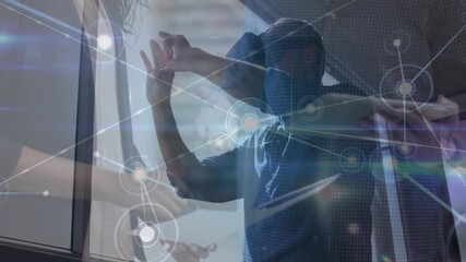 Male executive using virtual reality headset in office - Powered by Adobe