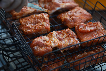 Grilling Marinated Meat: Juicy BBQ Pork Sizzling on Outdoor Grill Grate
