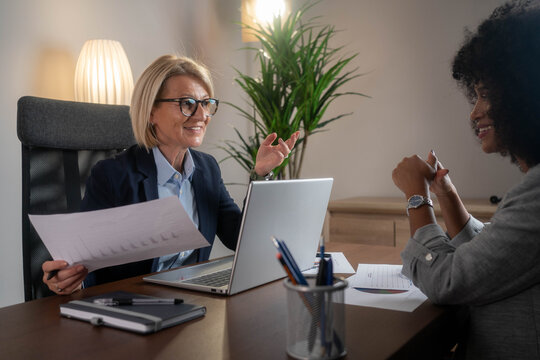 Woman consulting with a female financial manager at the bank.	