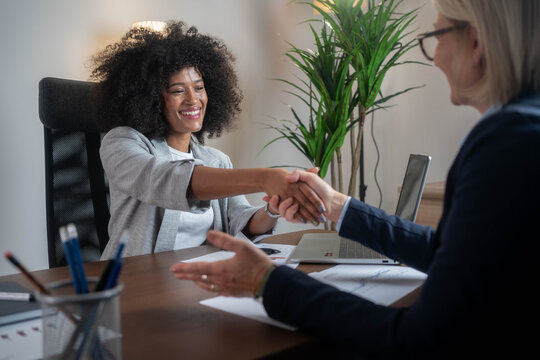Businesswoman handshake with client, diverse woman in banking agreement and HR contract