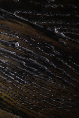 Close-up of Dark Textured Wooden Surface with Natural Patterns and Grooves